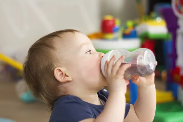 child drinking water from a bottle