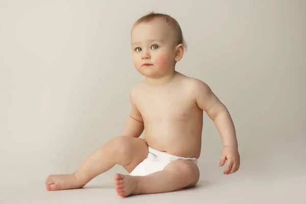 Portret van een kind met blauwe ogen op een grijze achtergrond — Stockfoto