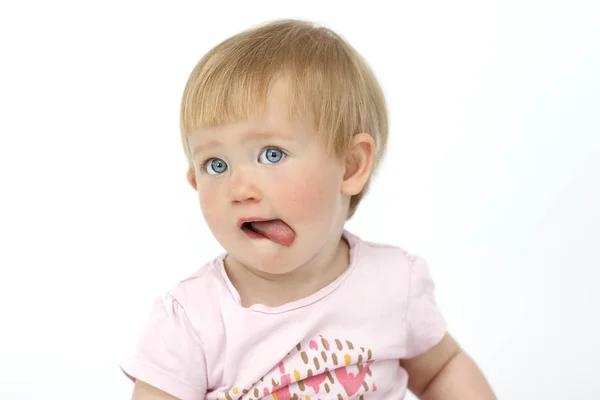 A little girl shows tongue — Stock Photo, Image