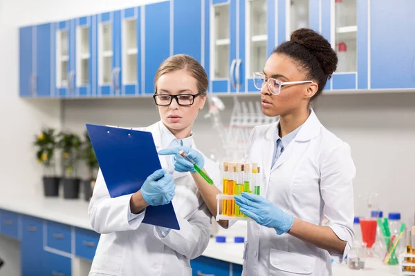 Scientists working with test tubes — Stock Photo, Image