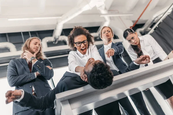 Businesswomen punishing businessman — Stock Photo, Image