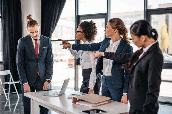 Businesspeople pointing at colleague — Stock Photo, Image