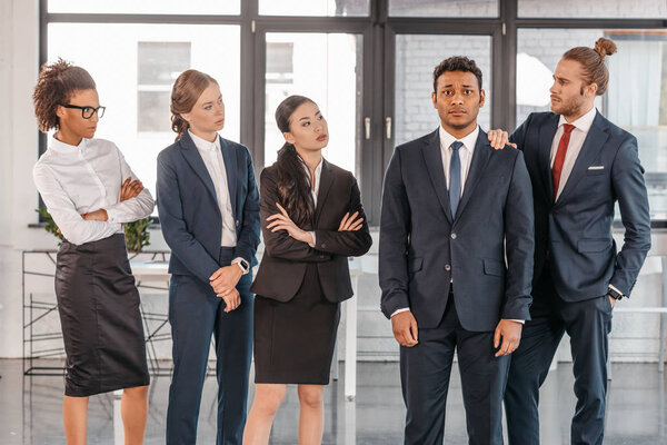 young businesspeople in formalwear at modern office