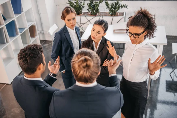 Coworkers in formalwear arguing at business meeting — Stock Photo, Image