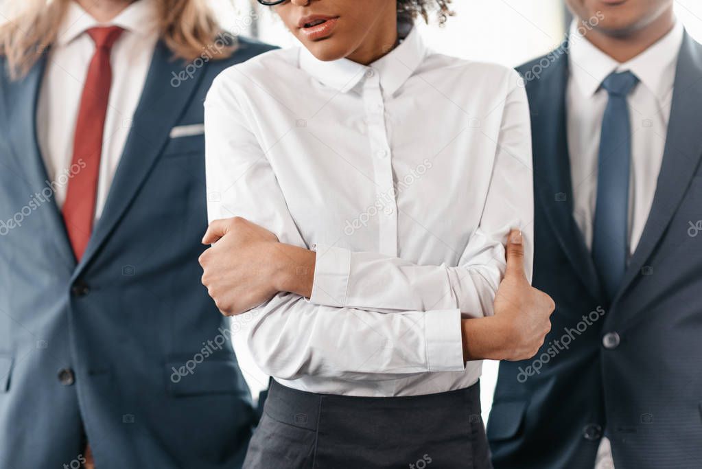 businesswoman and businessmen standing in office