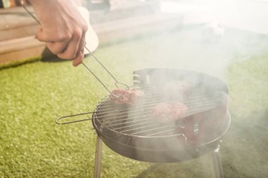 Person grilling burgers  clipart