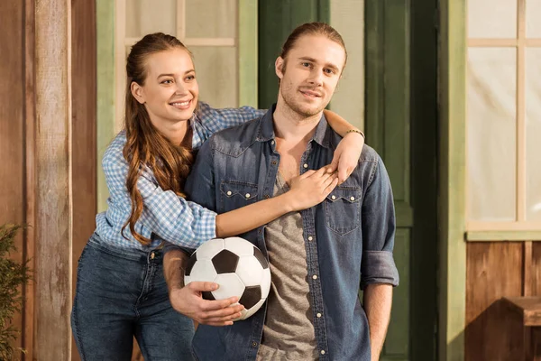 couple holding soccer ball