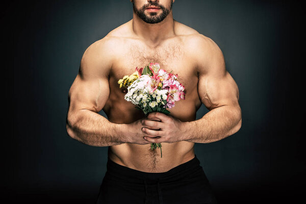 sportive man with bouquet of flowers