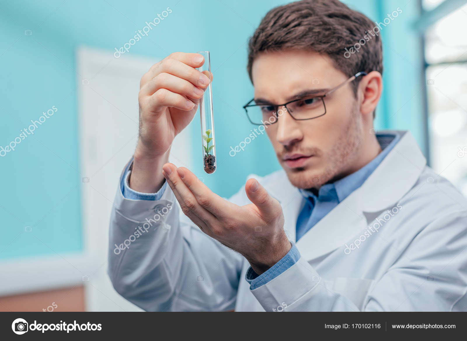 Biologist with plant in flask Stock Photo by ©AlexFedorenko 170102116
