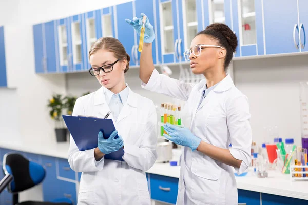 Scientists working with test tubes — Stock Photo