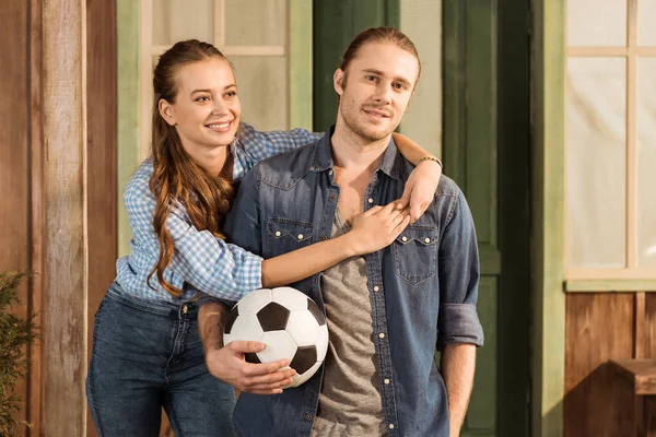 Couple holding soccer ball — Stock Photo