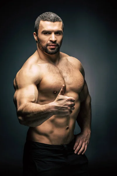 Athletic man showing thumb up — Stock Photo