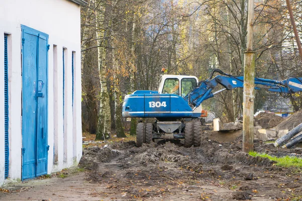 blue excavator is engaged in excavation work in the Park