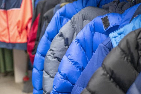 sports jackets of different colors hang on a hanger