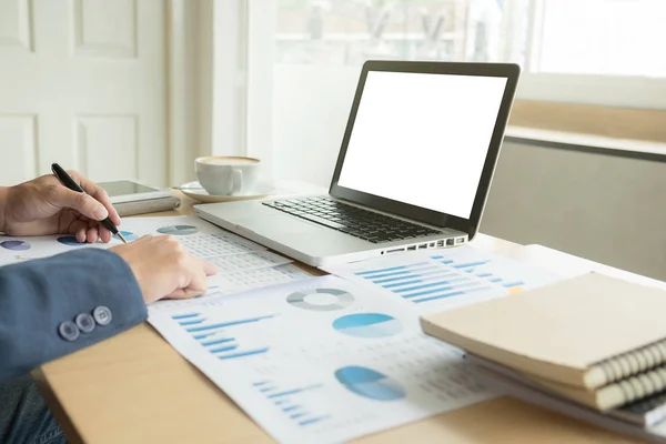 Business man working at office with laptop, and financial graph — Stock Photo, Image