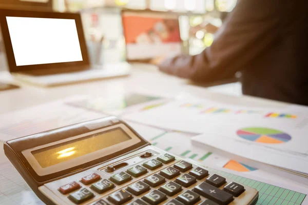 Close up of calculator and business man working document and lap — Stock Photo, Image