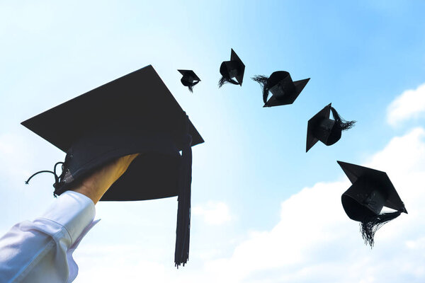 Graduation day, Images of hand holding Caps or hat throwing in t