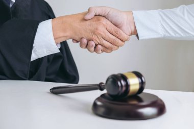Eller, erkek avukat ya da yargıç ve istemci üzerinde el sıkışan görüntü