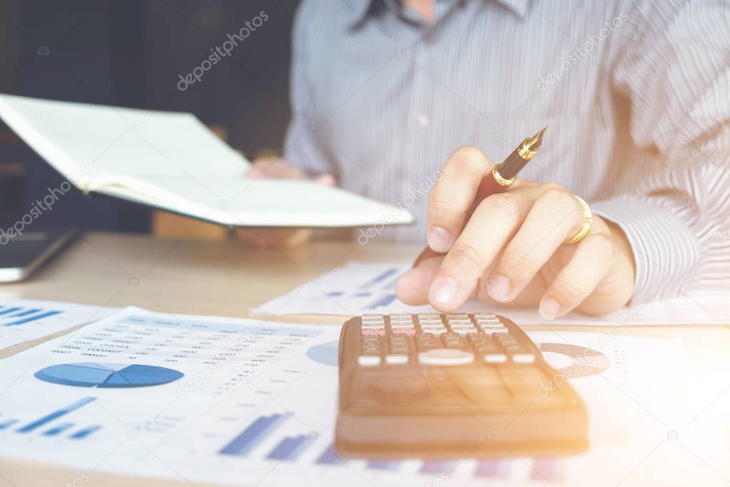 Business man or accountant working Financial investment on calcu