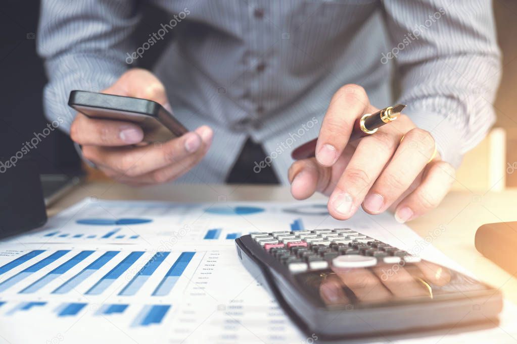 Business man or accountant working Financial investment on calcu