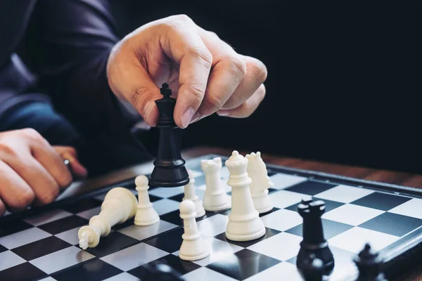 Close up of hands confident businessman colleagues playing chess — Stock Photo, Image