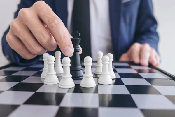 Close up of hands confident businessman playing chess game to de — Stock Photo, Image
