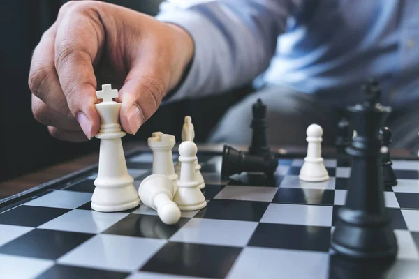 Close up of hands confident businessman colleagues playing chess — Stock Photo, Image