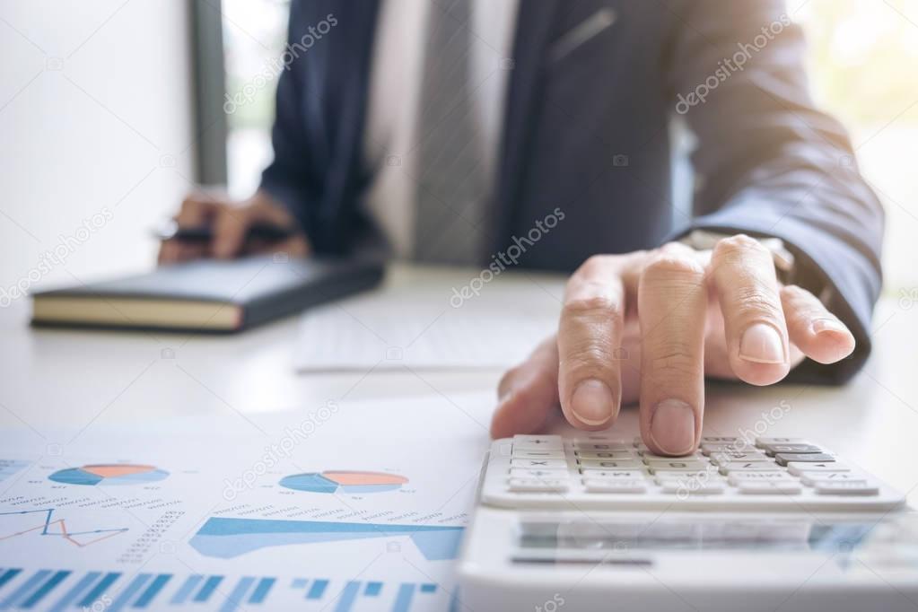 Business man or accountant working Financial investment on calcu