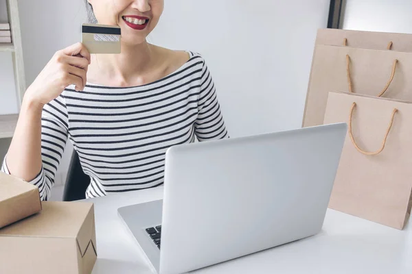 Mujer feliz usando el teléfono inteligente y pagos de registro de tarjetas de crédito —  Fotos de Stock