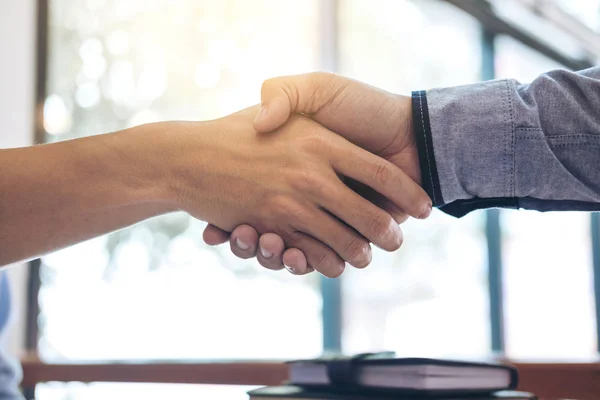 Two smiling businessman shaking hands together after good deal c — Stock Photo, Image