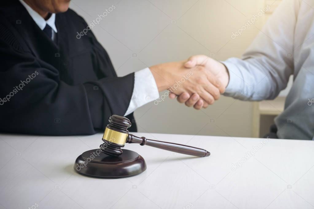 Image of hands, Male lawyer or judge and client shaking hands on