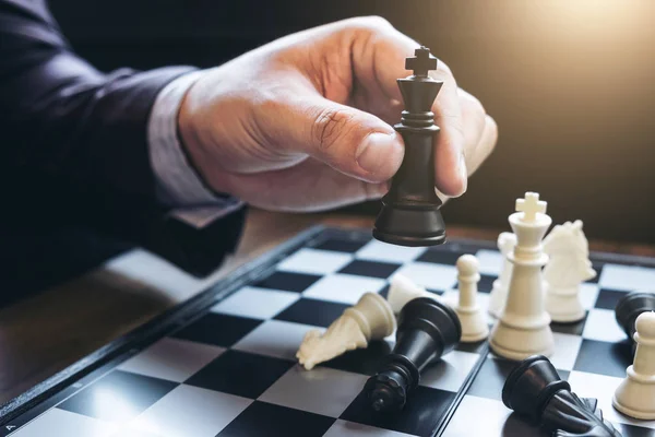 Close up of hands confident businessman colleagues playing chess — Stock Photo, Image