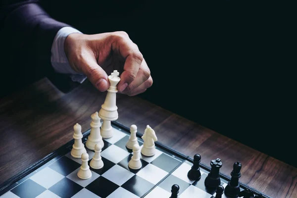Close up of hands confident businessman colleagues playing chess — Stock Photo, Image