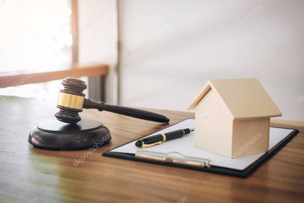 Gavel on sounding block at courtroom for decide home insurance, 