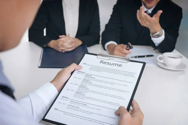 Interviewer or Board reading a resume during a job interview, Em — Stock Photo, Image