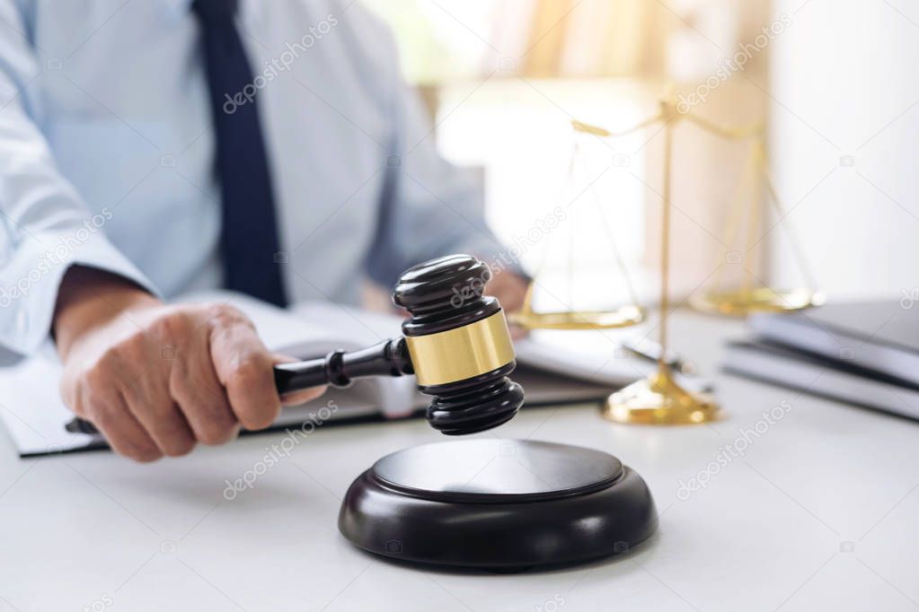 Judge gavel with scales of justice, male lawyers working having 