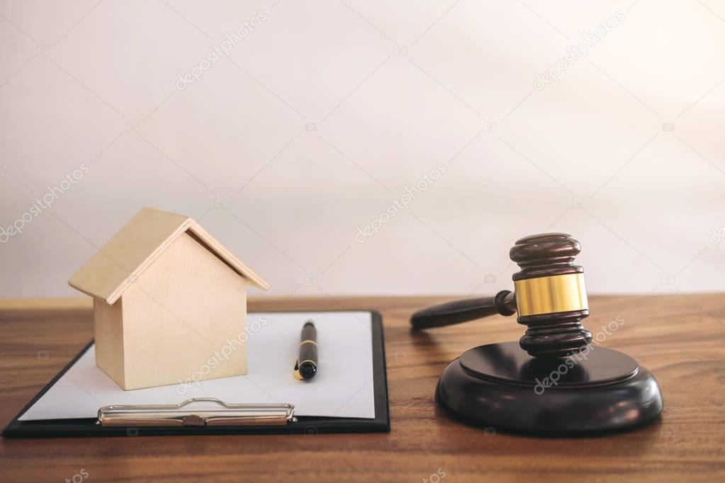 Gavel on sounding block at courtroom for decide home insurance, 