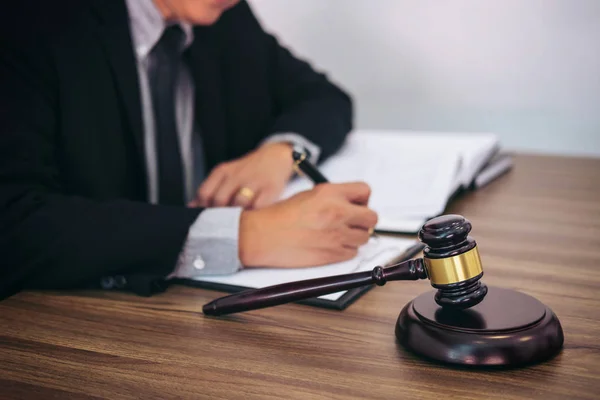 Gavel on wooden table and Lawyer or Judge working with agreement — Stock Photo, Image