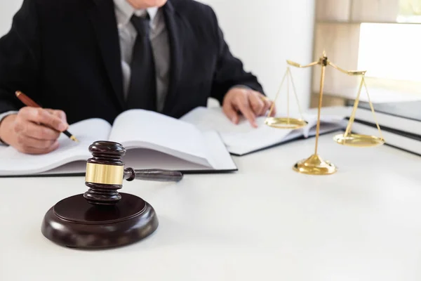 Close up of gavel, Male lawyer or judge working with Law books,