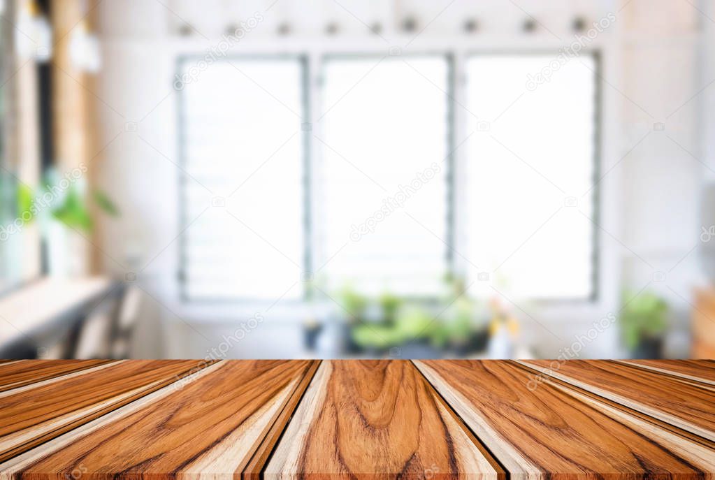 Empty wooden table and blurred background of abstract in front o