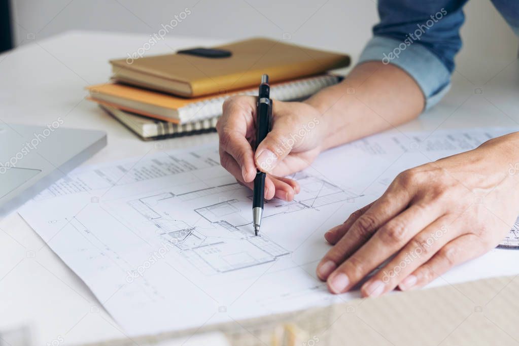 Architect working on blueprint, Engineer working with engineerin