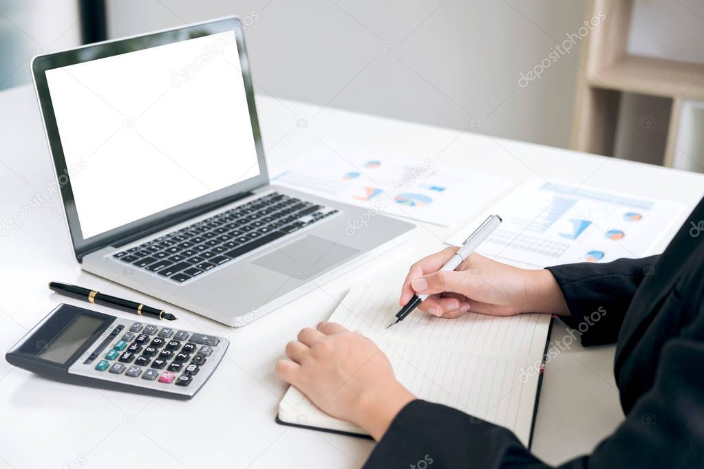 Female accountant calculations and analyzing financial graph dat