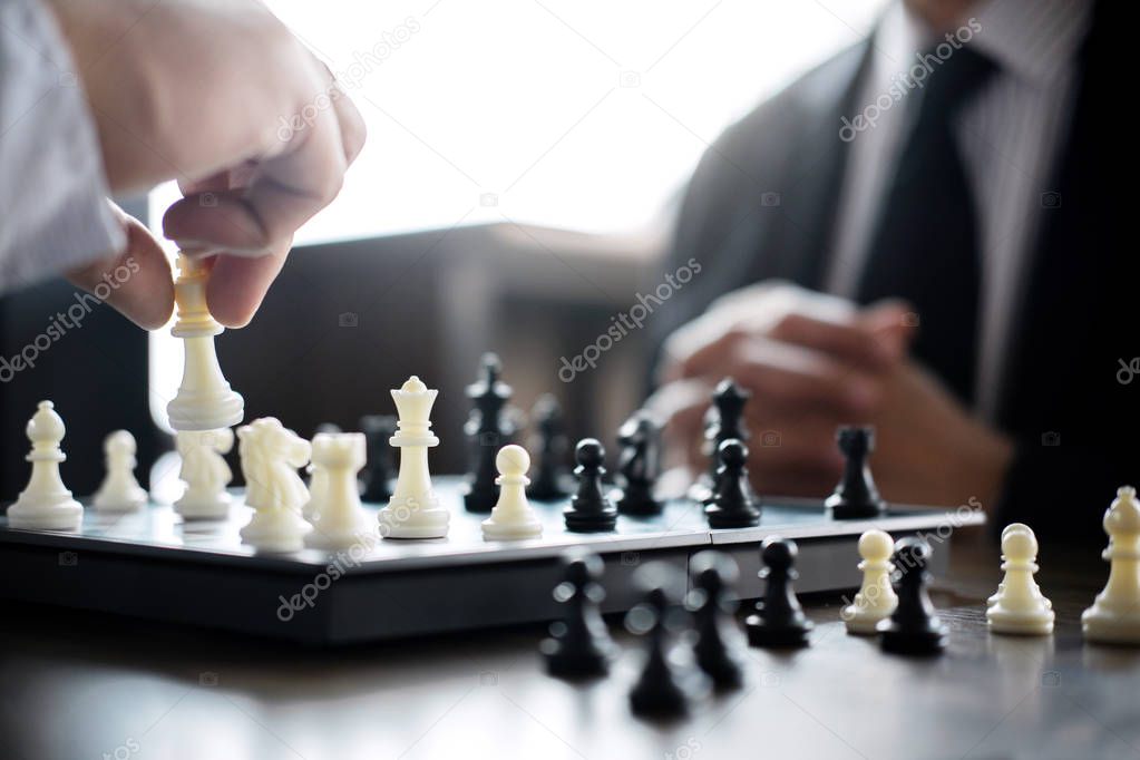 Confident businessman colleagues playing chess game overcome the