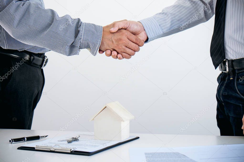 Home loan insurance concept, broker agent shaking hands with cus