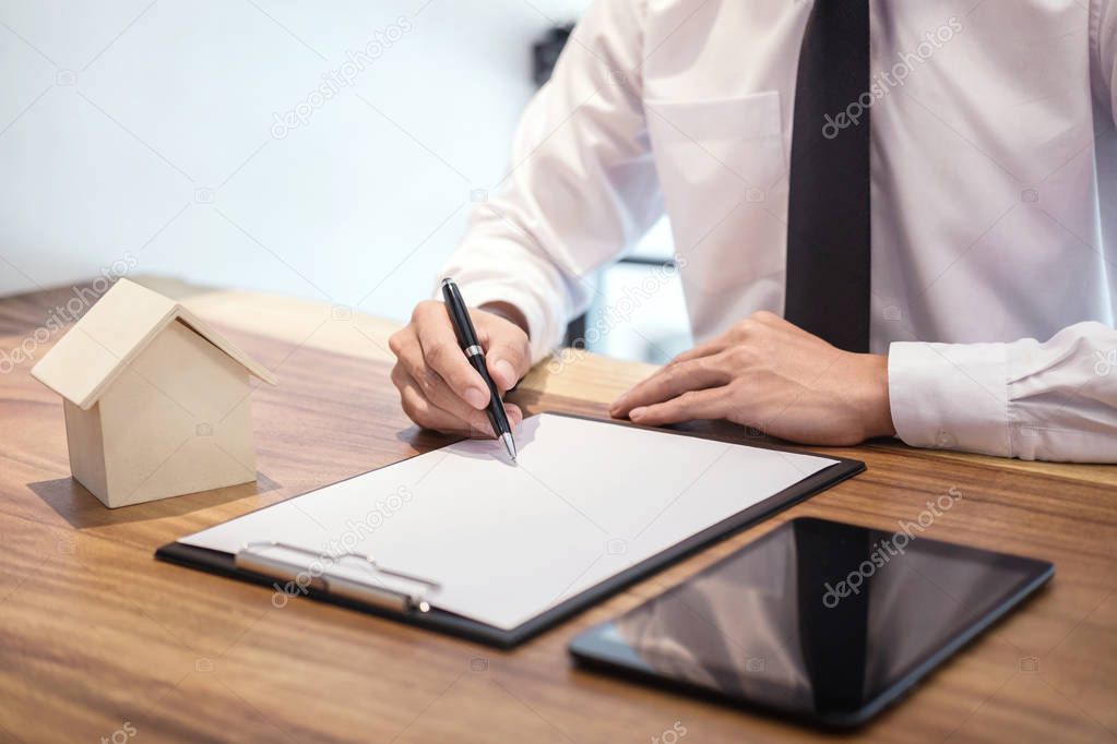 Man signing contract of loan agreement document with bank broker