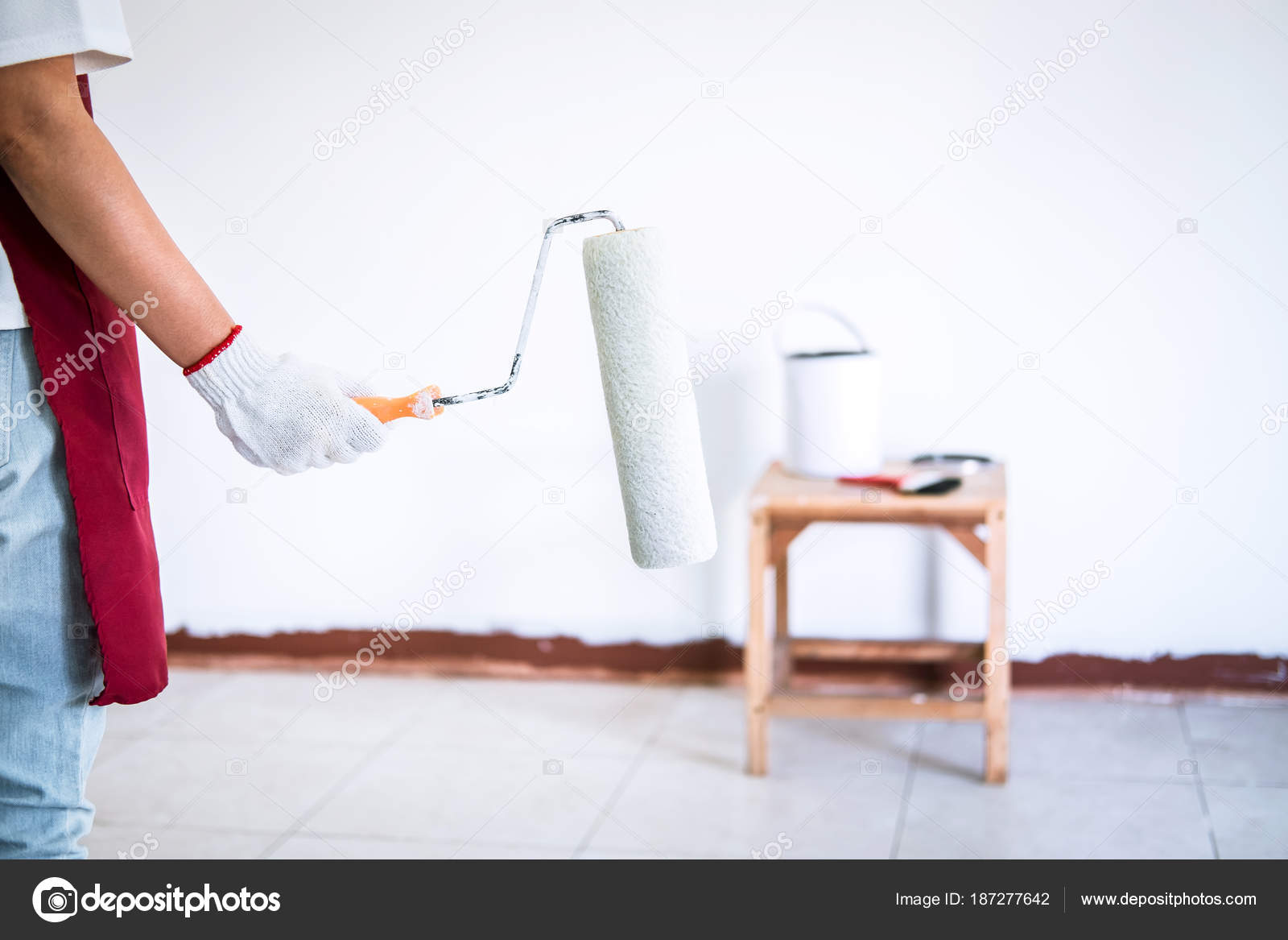 Interior working, Painter hand in white glove painting wall with Stock