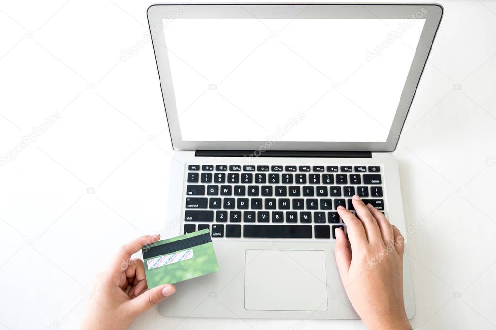 Business woman holding credit card entering security code and us
