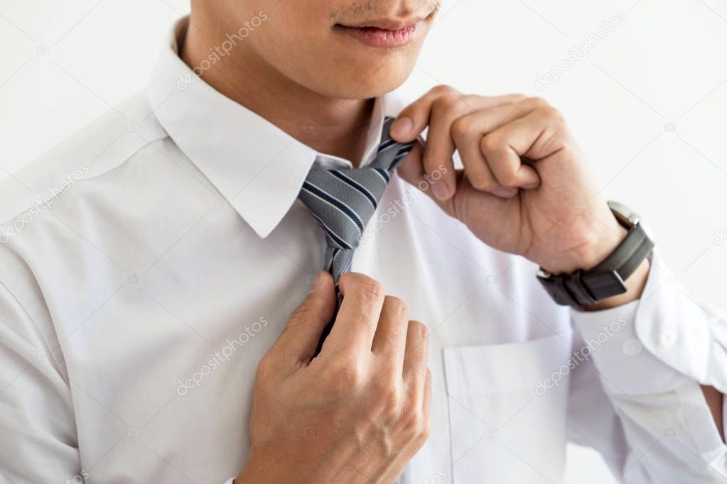 Close up of Young attractive businessman wears a gray tie and ad