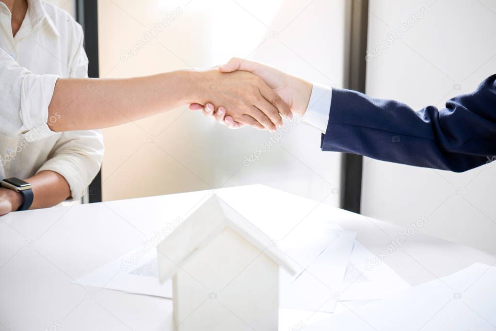 Handshake after good cooperation, Real estate broker residential