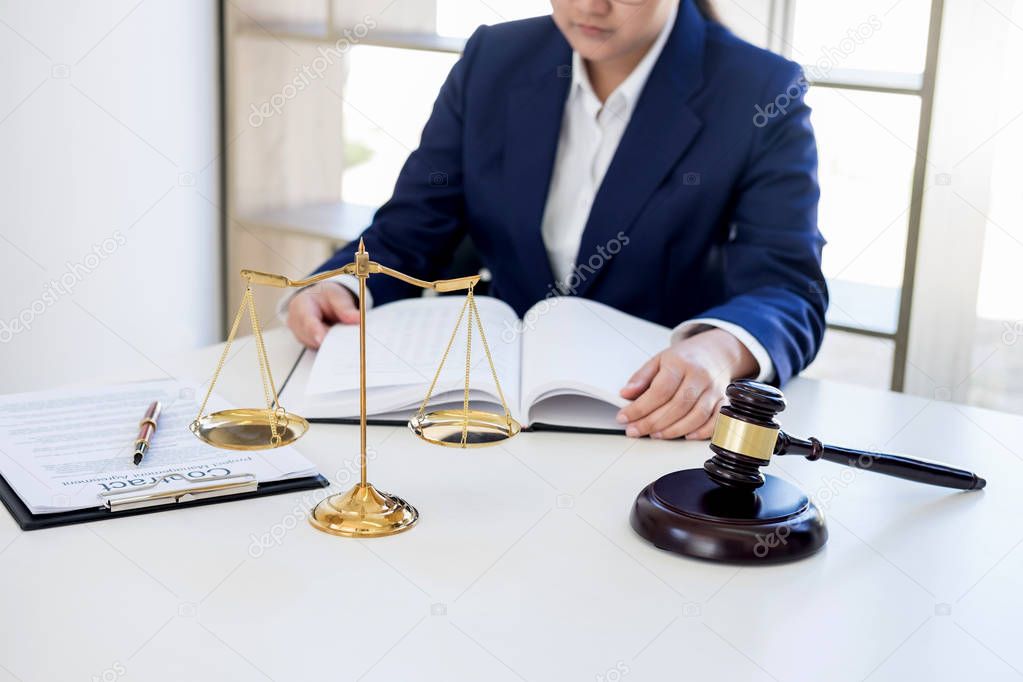 Judge gavel with scales of justice, professional female lawyers 